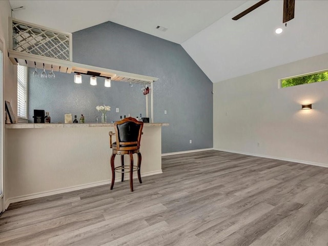 unfurnished living room featuring hardwood / wood-style floors, ceiling fan, and lofted ceiling