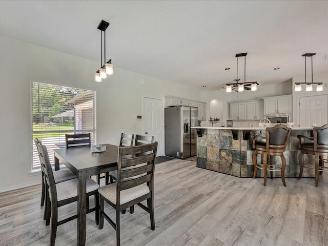 dining space with light hardwood / wood-style floors