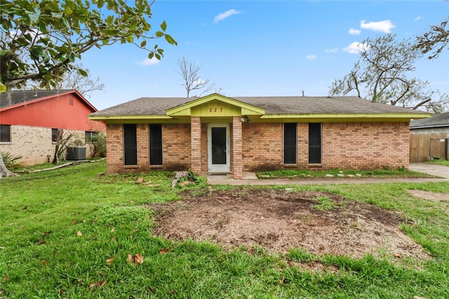 ranch-style house featuring a front yard and central AC