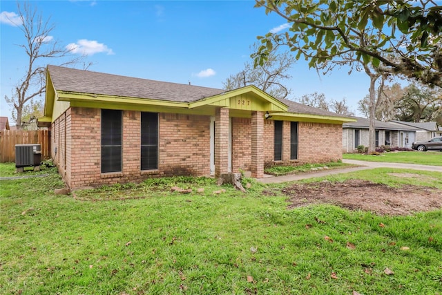 ranch-style home featuring a front yard and central AC