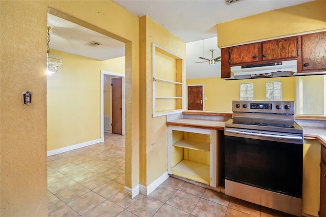 kitchen with stainless steel range with electric stovetop, ceiling fan, light tile patterned floors, decorative light fixtures, and built in features