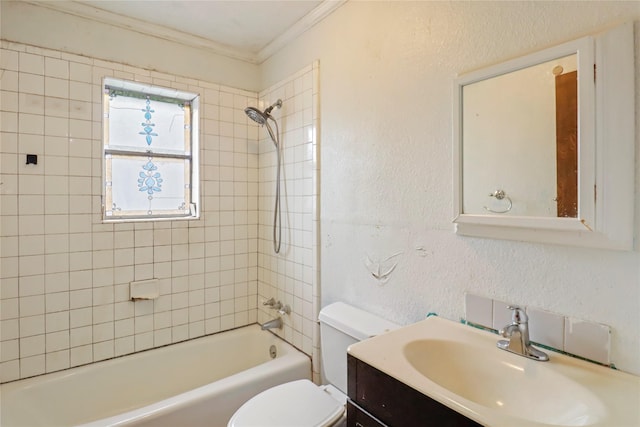 full bathroom featuring crown molding, toilet, vanity, and tiled shower / bath