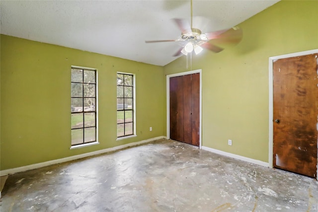 unfurnished bedroom with ceiling fan and vaulted ceiling