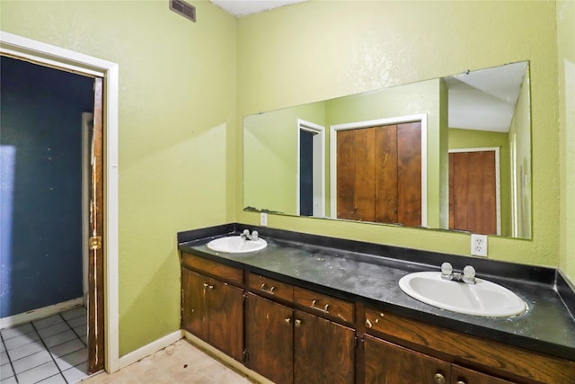 bathroom with tile patterned floors and vanity