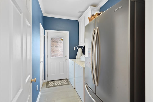 clothes washing area with cabinets, independent washer and dryer, and ornamental molding