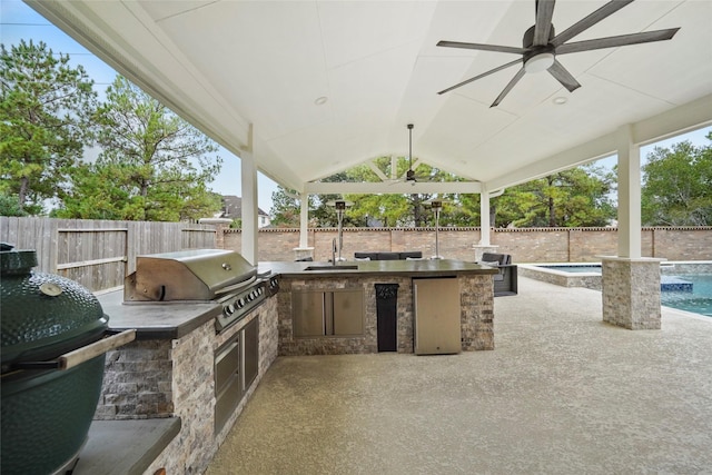 view of patio / terrace featuring area for grilling, sink, and ceiling fan