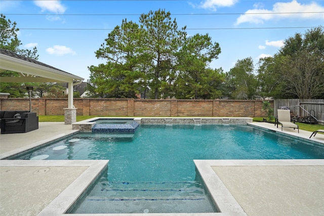 view of swimming pool with an in ground hot tub and a patio area