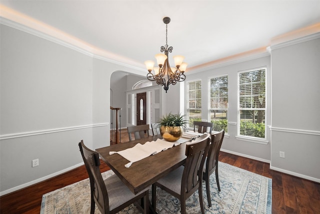 dining space featuring crown molding, a chandelier, and dark hardwood / wood-style flooring