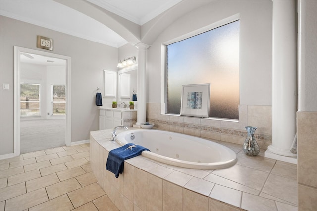 bathroom featuring a relaxing tiled tub, ornamental molding, decorative columns, and vanity