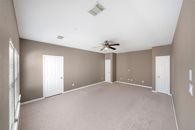 unfurnished room featuring ceiling fan and light carpet