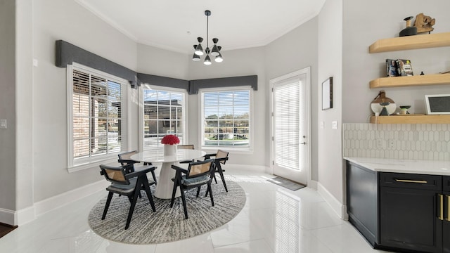 dining room featuring light tile patterned flooring, crown molding, and a chandelier