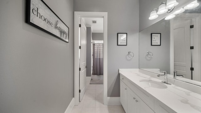 bathroom with a shower with shower curtain, tile patterned flooring, and vanity