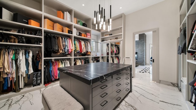 walk in closet with a chandelier