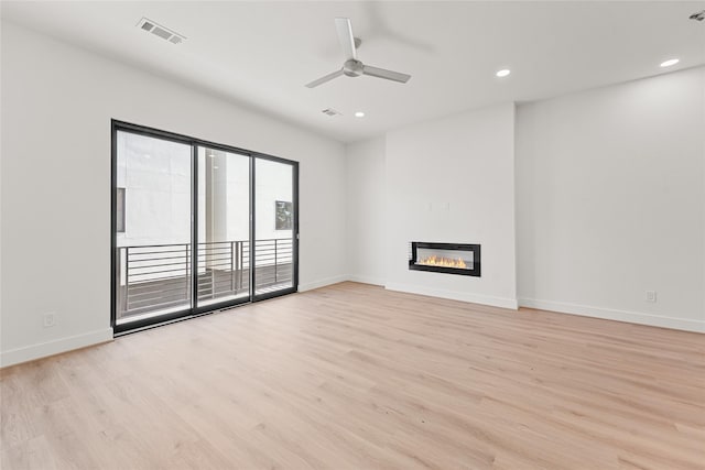 unfurnished living room with ceiling fan and light wood-type flooring