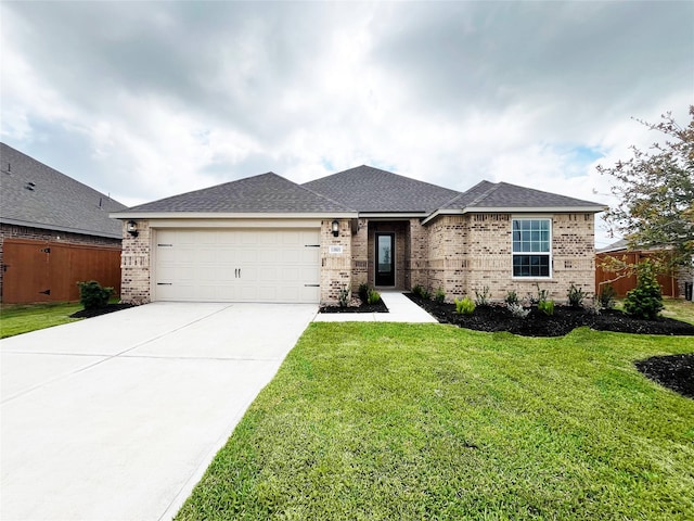 view of front of property featuring a garage and a front lawn