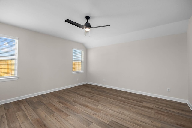 unfurnished room featuring hardwood / wood-style floors, ceiling fan, and vaulted ceiling