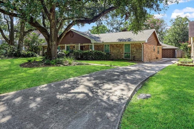 ranch-style home featuring a garage and a front lawn