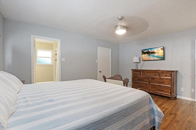 bedroom featuring ceiling fan, dark hardwood / wood-style flooring, and a textured ceiling