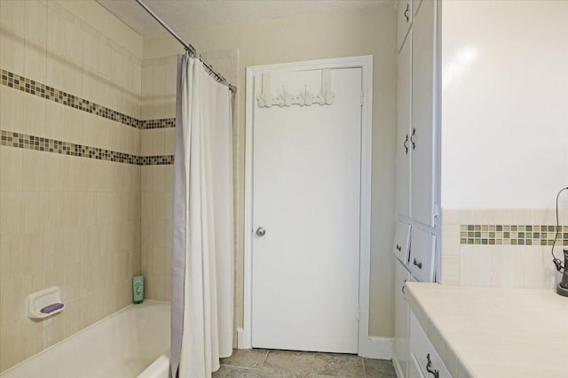 bathroom with shower / bath combo and vanity