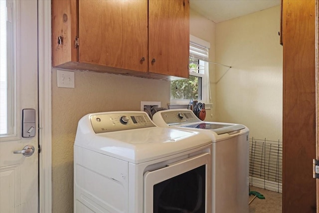 laundry area with cabinets and washer and clothes dryer