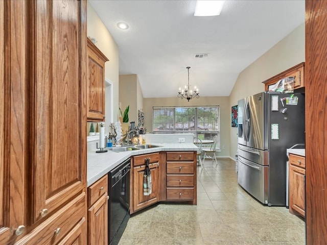 kitchen with sink, black dishwasher, a notable chandelier, stainless steel fridge, and decorative light fixtures