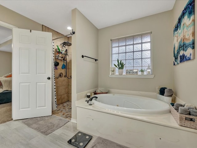 bathroom with separate shower and tub