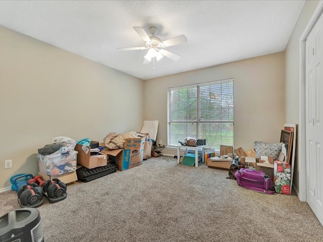 recreation room featuring ceiling fan and carpet