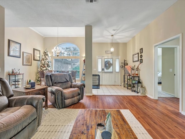 living room featuring light wood-type flooring and an inviting chandelier