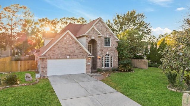 front facade featuring a garage and a yard