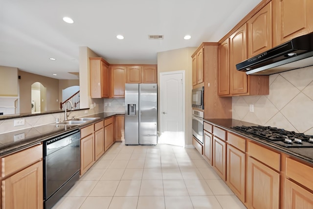 kitchen featuring backsplash, light tile patterned flooring, sink, and stainless steel appliances