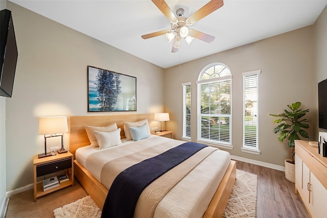 bedroom with ceiling fan and hardwood / wood-style flooring