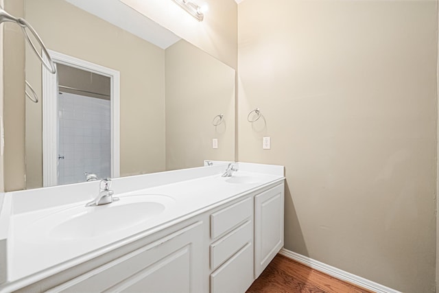 bathroom with hardwood / wood-style flooring and vanity