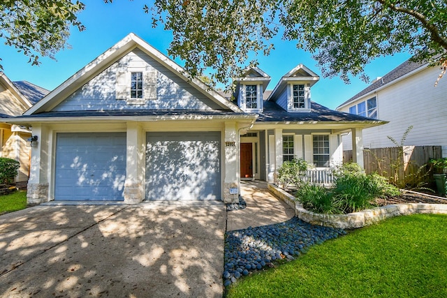 view of front of property with covered porch and a garage