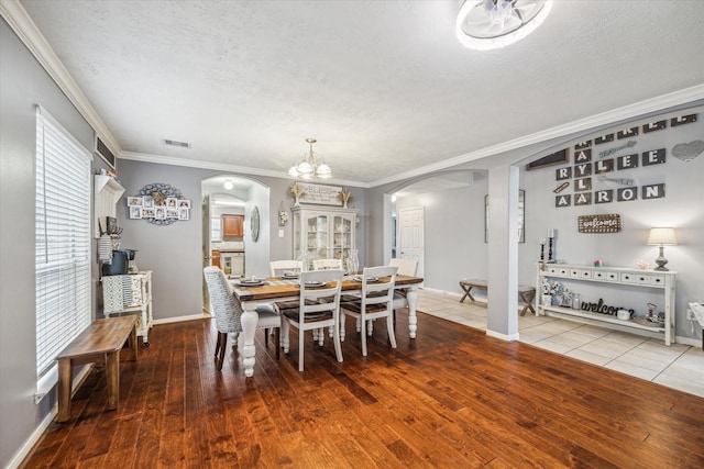 dining area with crown molding and wood-type flooring