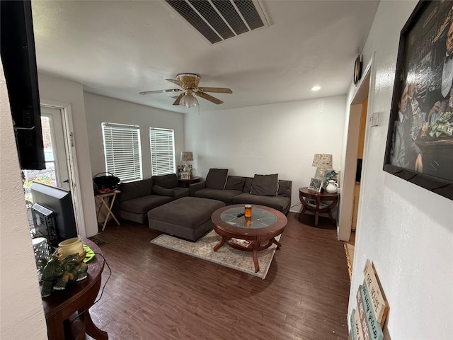 living room with ceiling fan and dark hardwood / wood-style floors