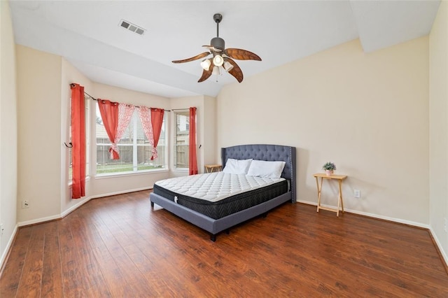 bedroom with ceiling fan, dark hardwood / wood-style floors, and vaulted ceiling