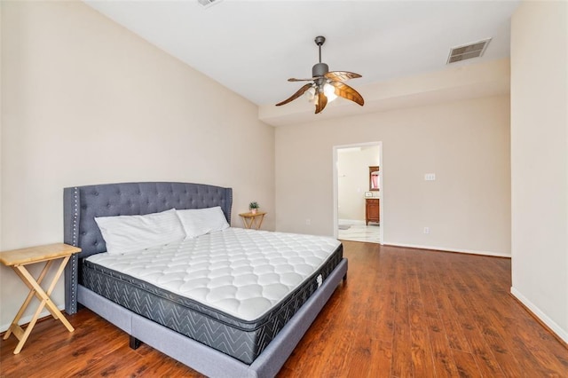 bedroom with ensuite bath, ceiling fan, and dark wood-type flooring