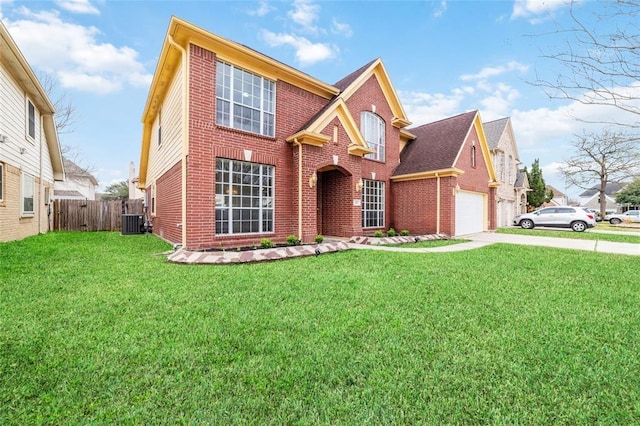 view of front property with central AC unit, a garage, and a front lawn