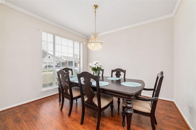 dining room with a chandelier, dark hardwood / wood-style floors, and ornamental molding