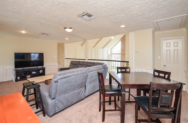 carpeted living room featuring a textured ceiling and ornamental molding