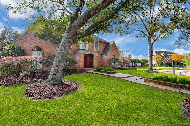 tudor house featuring a front yard