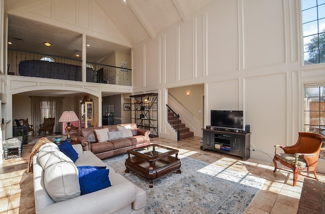 living room with light tile patterned floors and a high ceiling