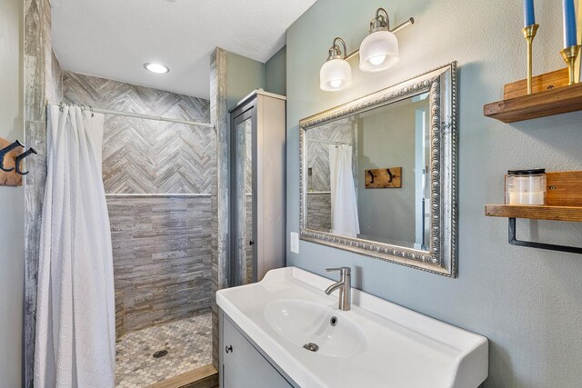 bathroom with curtained shower and vanity