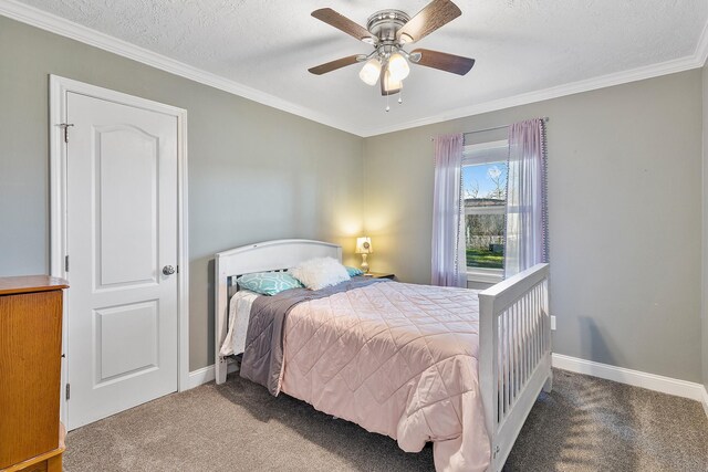 bedroom with ceiling fan, carpet floors, a textured ceiling, and ornamental molding