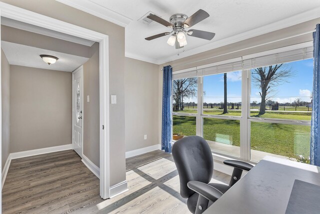 home office featuring hardwood / wood-style floors, ceiling fan, and crown molding