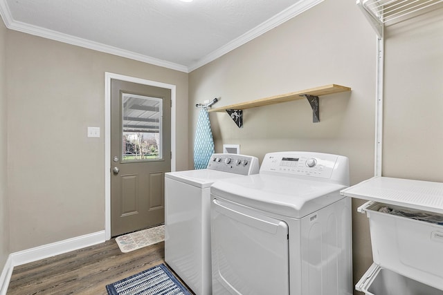 laundry area with washer and clothes dryer, dark wood-type flooring, and ornamental molding