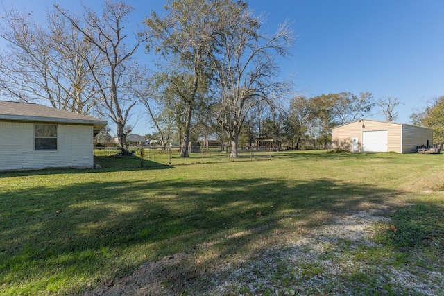 view of yard featuring an outbuilding and a garage