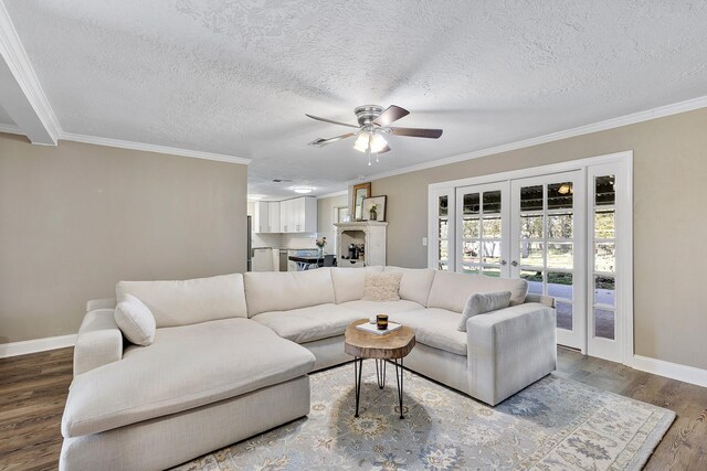 living room featuring french doors, ornamental molding, a textured ceiling, ceiling fan, and hardwood / wood-style floors