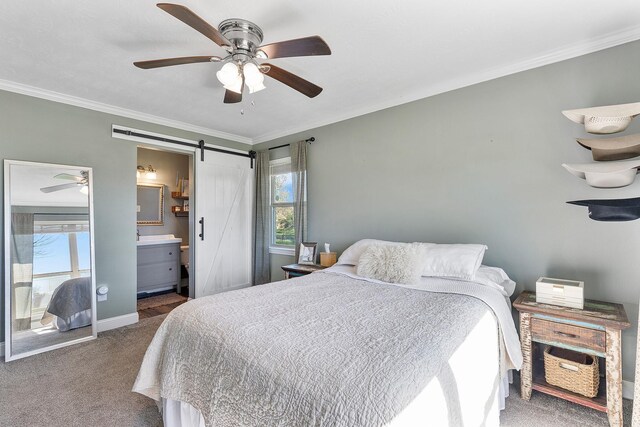 carpeted bedroom with a barn door, ceiling fan, crown molding, and connected bathroom