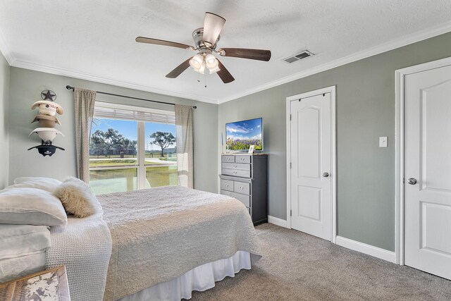 carpeted bedroom with ceiling fan, ornamental molding, and a textured ceiling